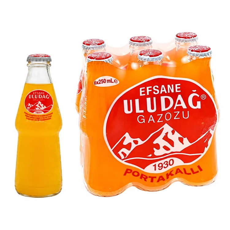 Uludag Orange Gazoz bottle beside an orange six-bottle multipack on white